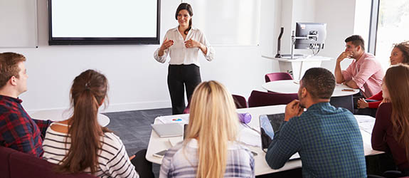 female lecturing a group of students