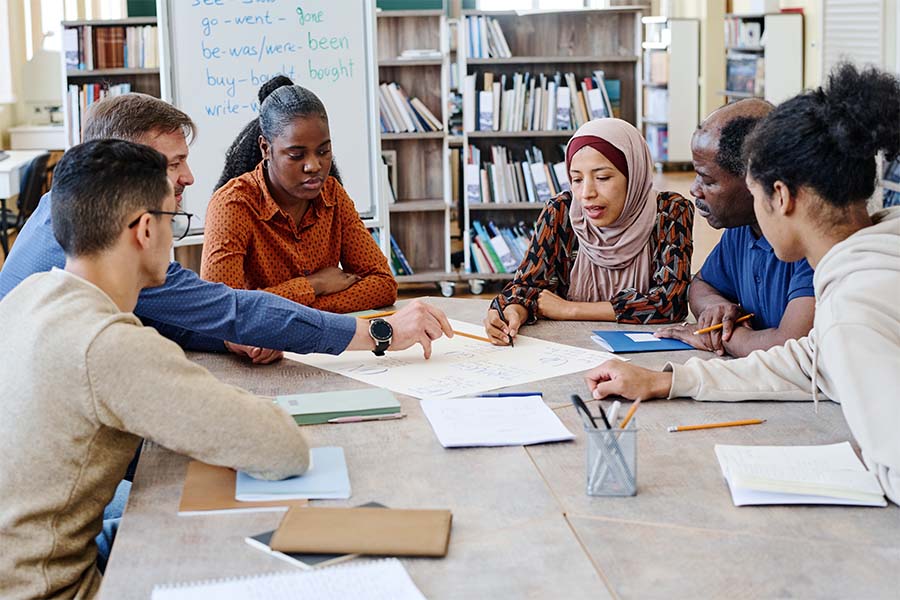 Diverse group of students hold a table discussion