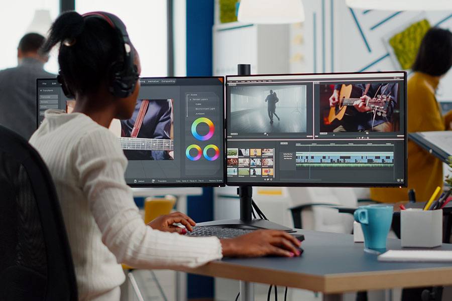 Videographer editing videos at a computer