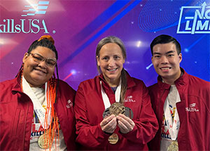Gold medal winners Dakota Reeves and Harrison Nguyen with advisor Kelly Sonnastine