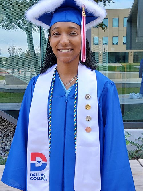 female stem student in blue cap and gown attire