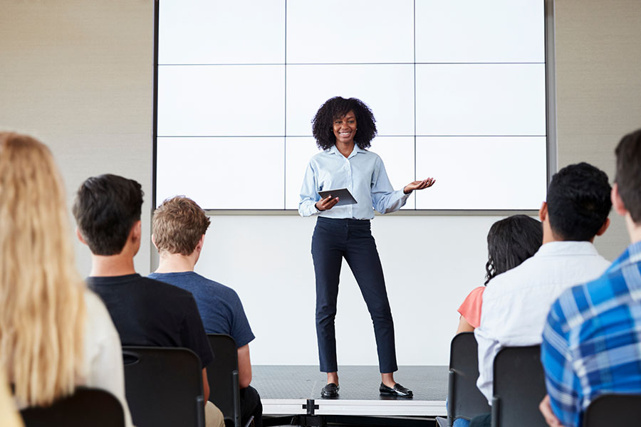 Woman presents in from of an audience