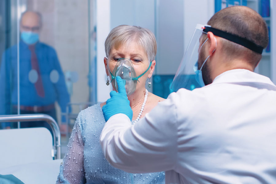 Patient taking oxygen from technician